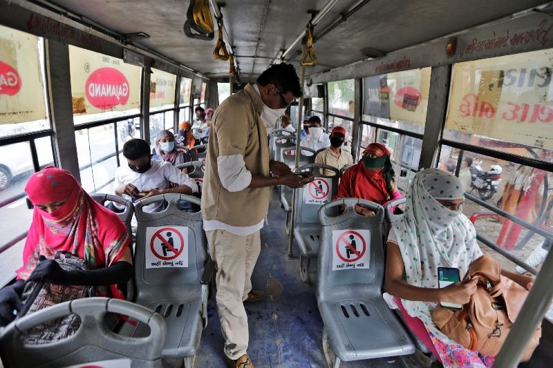 Indians board a city bus in Ahmedabad, India, Wednesday, June 10, 2020. India's coronavirus cases are spiking amid government reopening restaurants, shopping malls and religious places in most of its states after a more than 2-month-old lockdown. (Photo by Ajit Solanki/AP Photo)